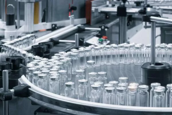 Vials on a conveyor belt during the sterile injectable filling process